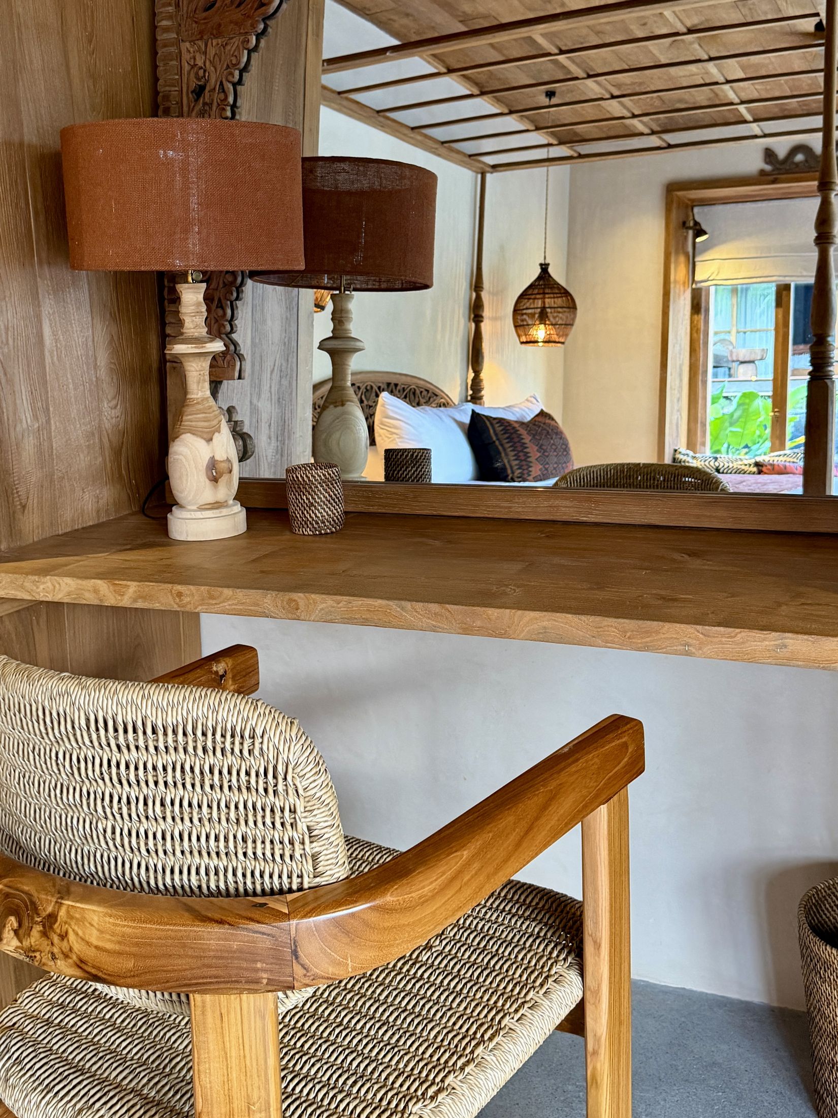 A bedroom desk and vanity nook with woven lamps