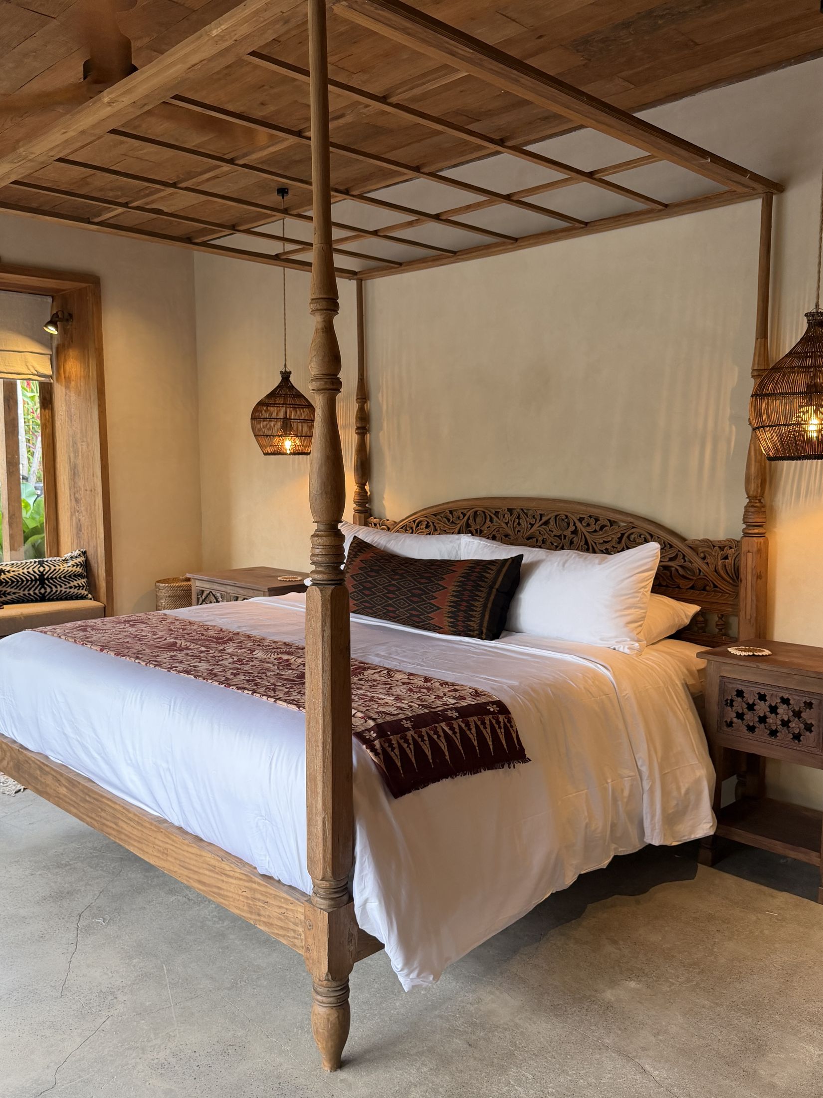 A second en suite bedroom with a carved canopy bed