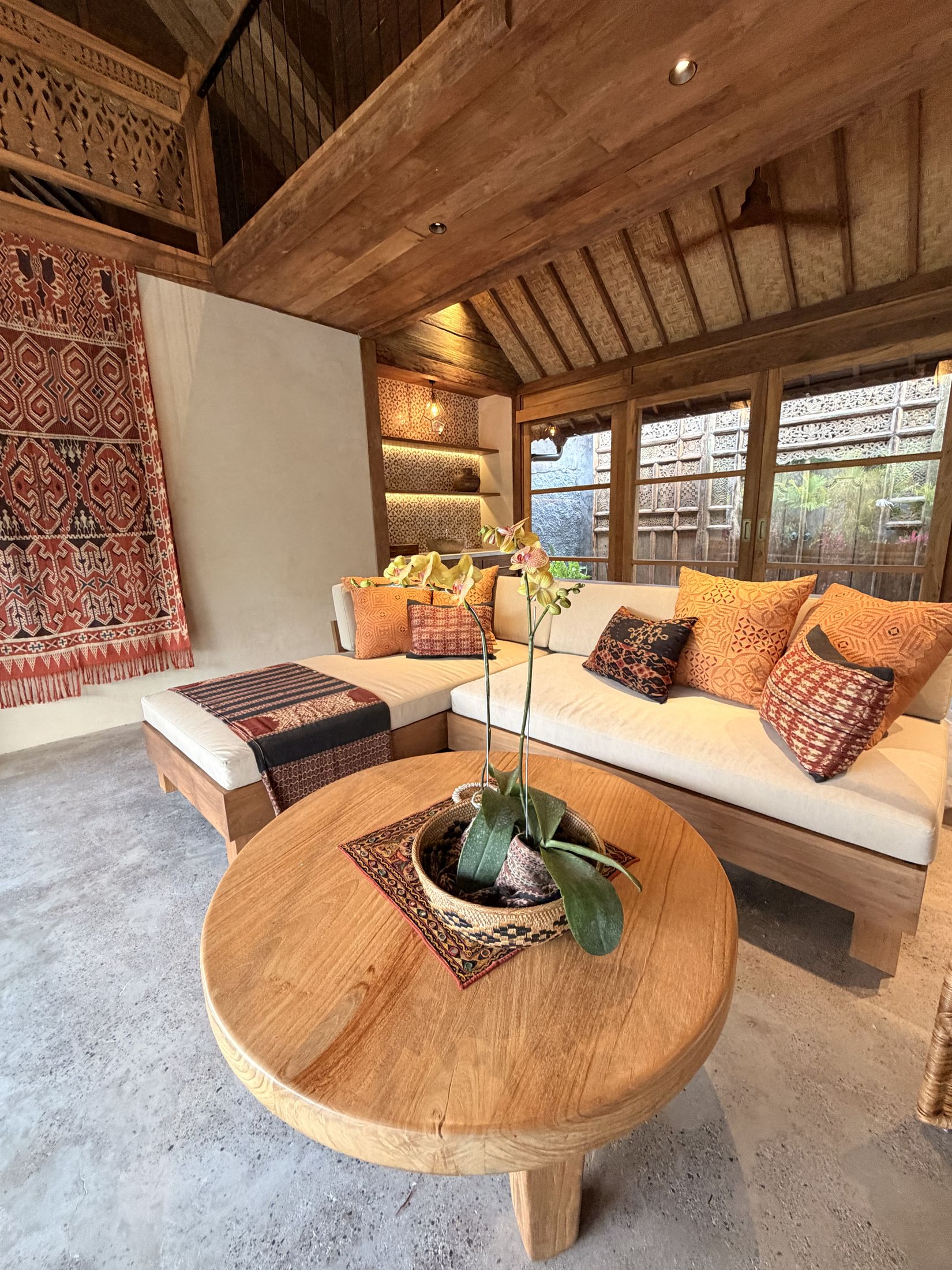 Long House living room styled with handwoven ikat textiles and cushions