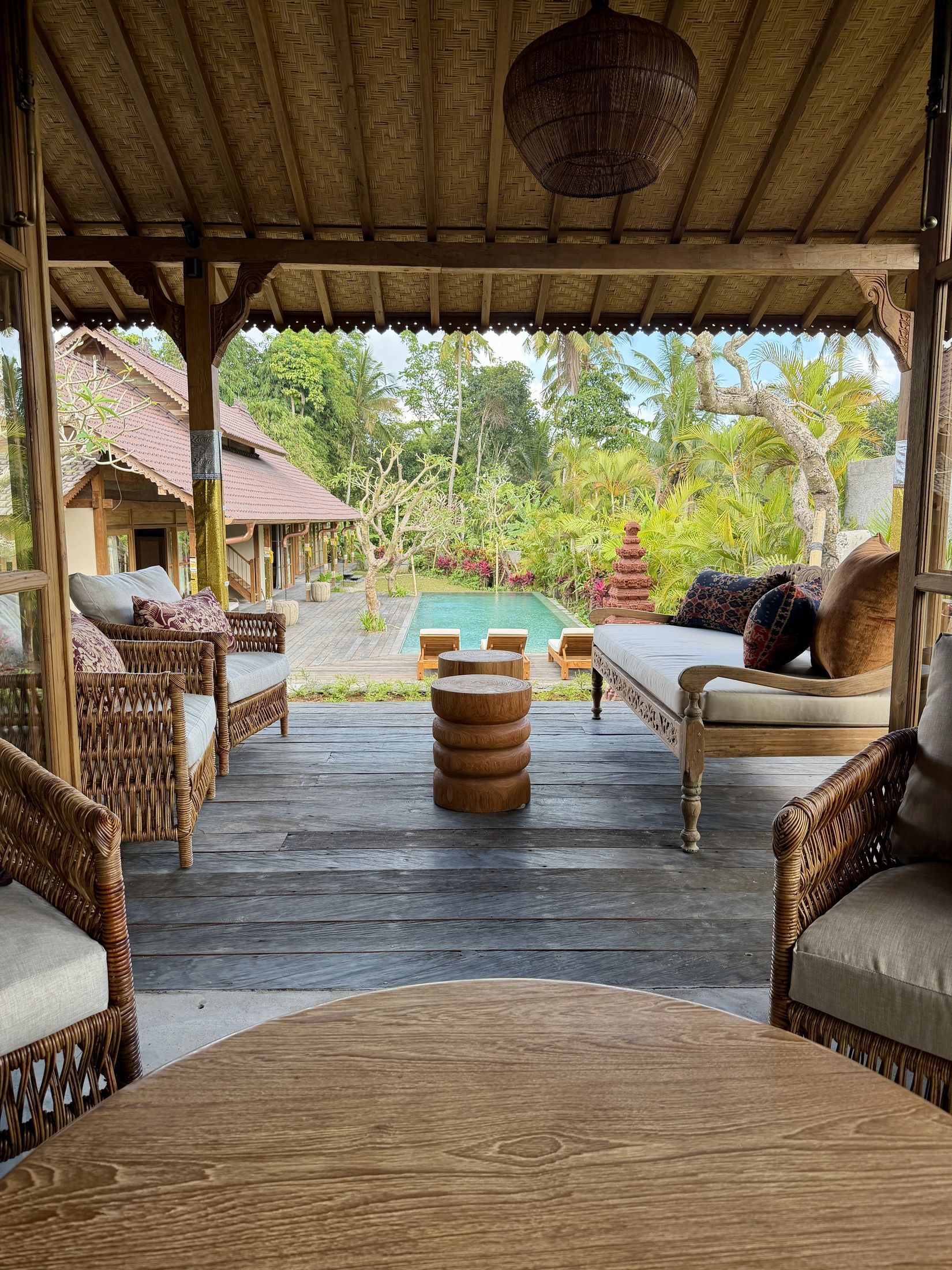 Covered terrace lounge opening onto the pool deck